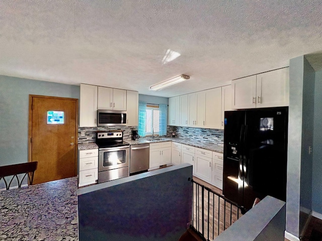 kitchen with sink, white cabinets, and appliances with stainless steel finishes