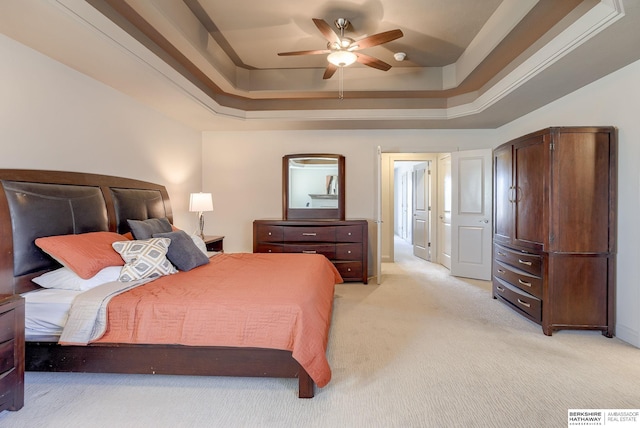 bedroom with ceiling fan, a tray ceiling, visible vents, and light carpet