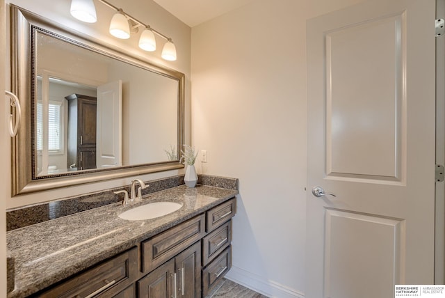 bathroom with vanity and baseboards