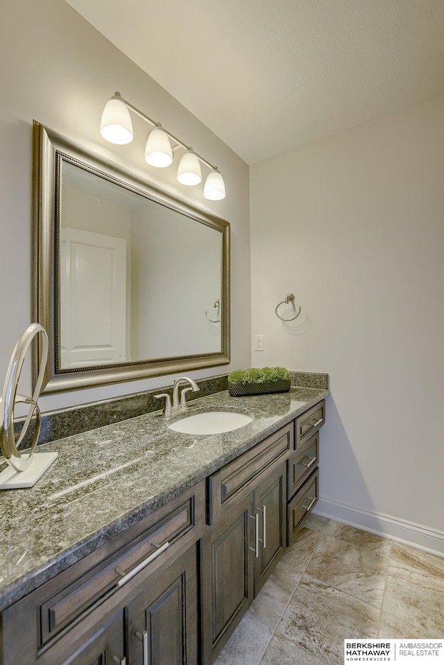 bathroom featuring vanity and baseboards