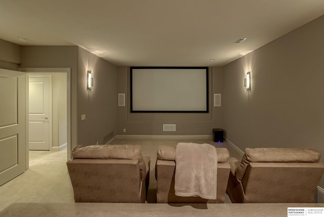 carpeted home theater with visible vents and baseboards