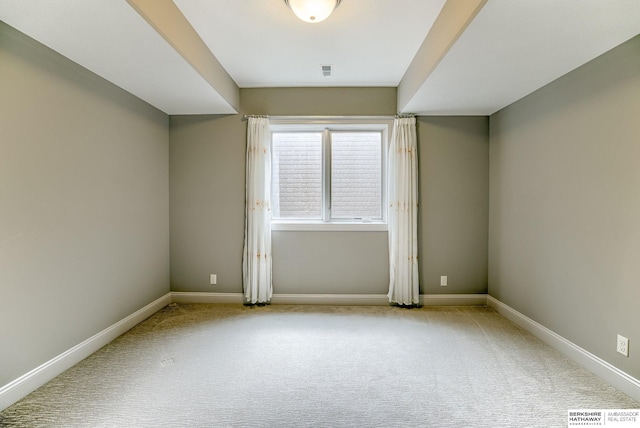 empty room featuring visible vents, baseboards, and carpet floors