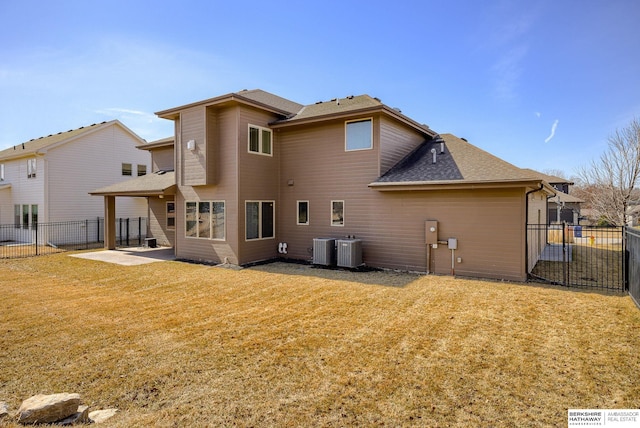 back of house featuring a fenced backyard, central air condition unit, a patio, and a yard