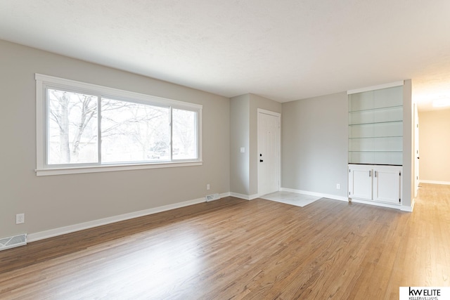 spare room featuring light wood-type flooring