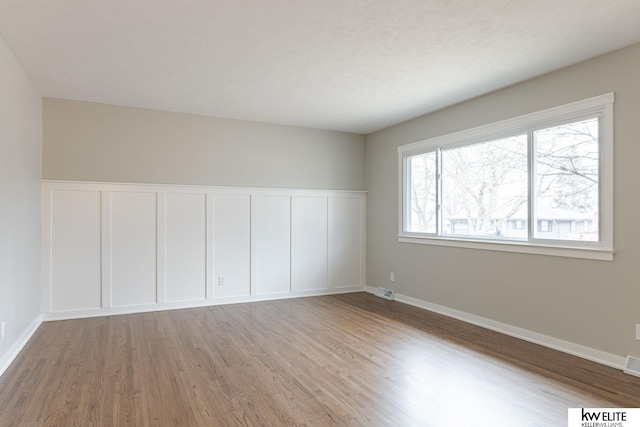 spare room with hardwood / wood-style floors