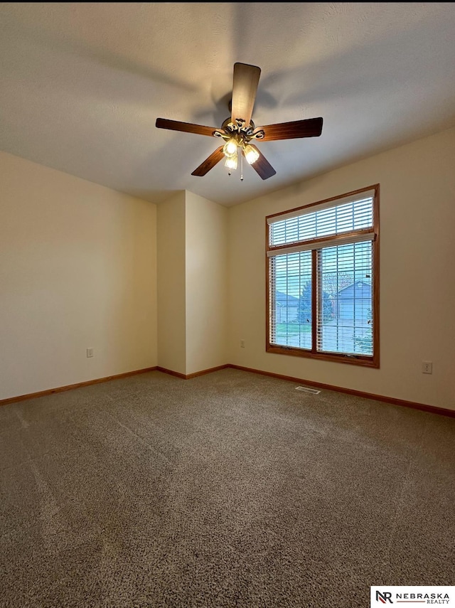 carpeted spare room with ceiling fan