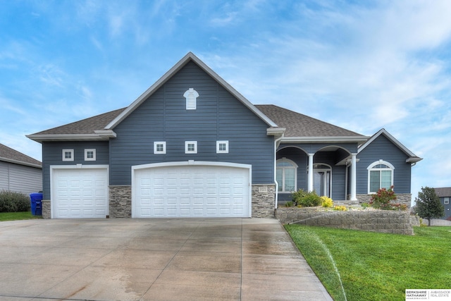 view of front facade with a garage and a front lawn