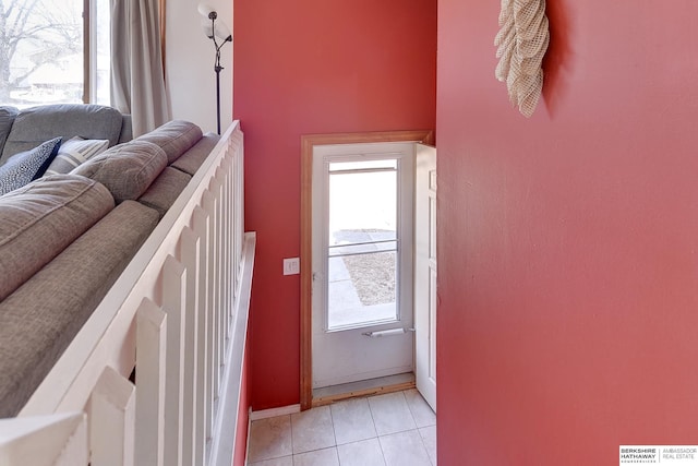 doorway featuring light tile patterned flooring