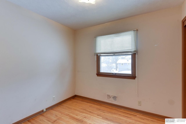 unfurnished room featuring light hardwood / wood-style flooring