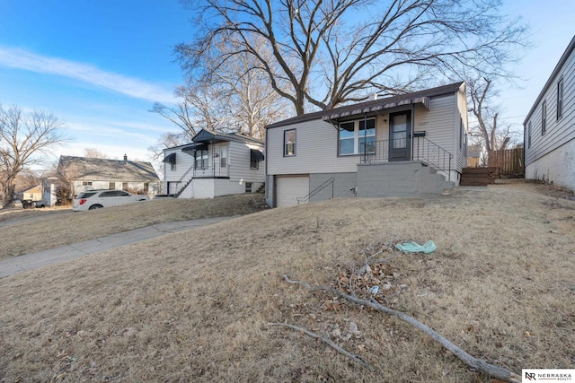 view of front of home with a garage and a front yard