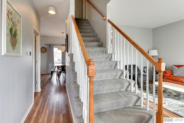 stairs featuring wood-type flooring