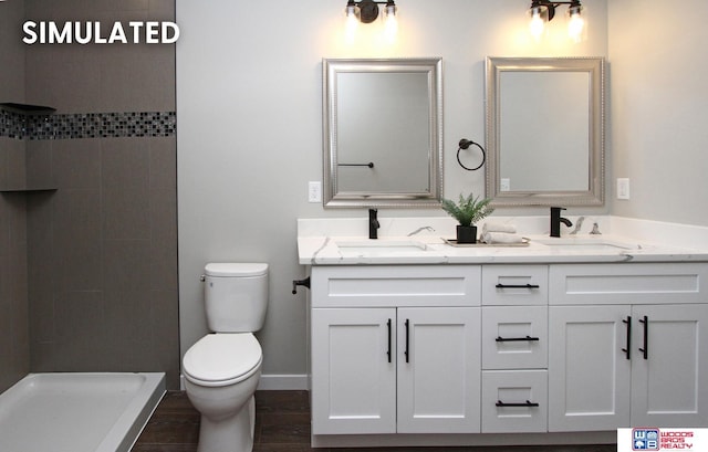 bathroom with hardwood / wood-style flooring, vanity, walk in shower, and toilet