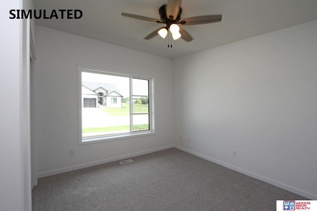 carpeted spare room featuring ceiling fan