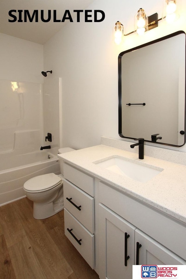 full bathroom with wood-type flooring, bathtub / shower combination, vanity, and toilet