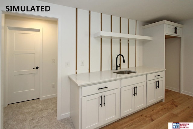 kitchen with white cabinetry and sink