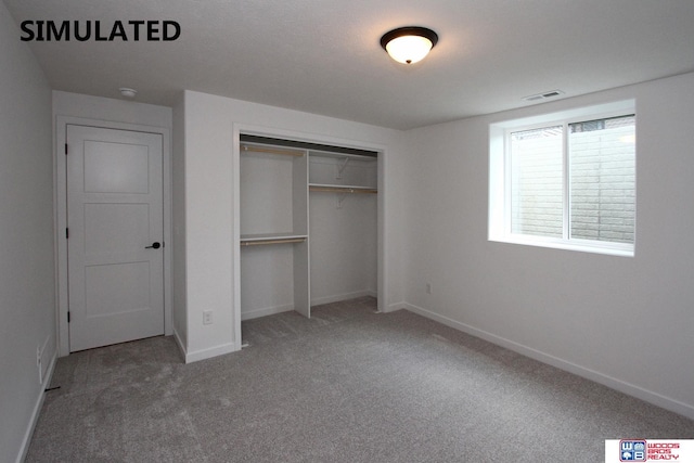 unfurnished bedroom featuring carpet flooring and a closet