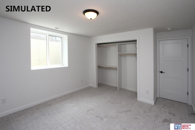 unfurnished bedroom featuring a closet and light carpet