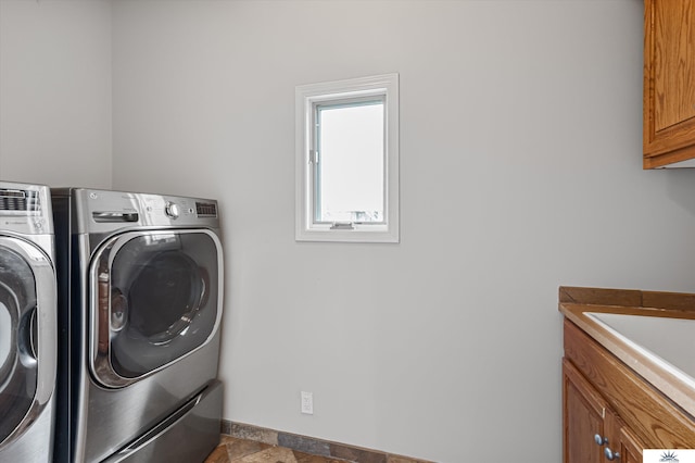 laundry area with cabinets, sink, and washer and clothes dryer