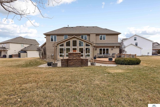 back of property featuring a yard and a deck