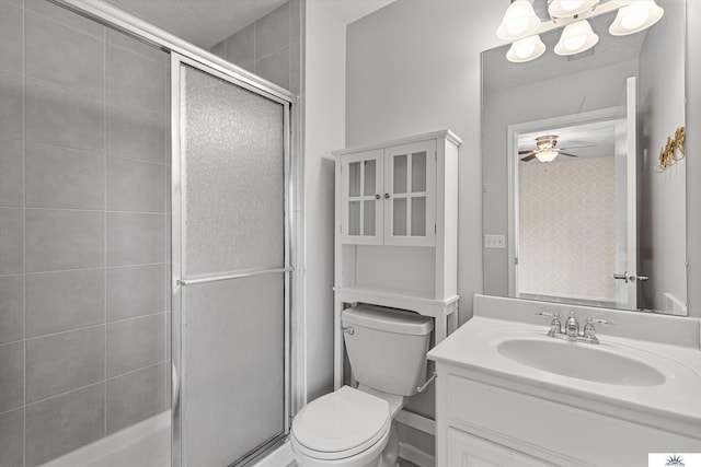 bathroom with vanity, ceiling fan, toilet, and walk in shower