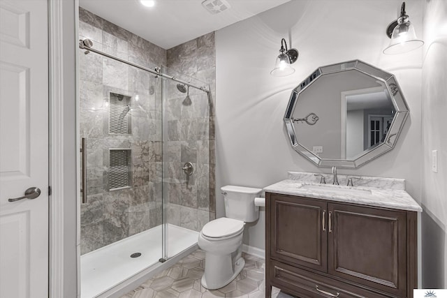 bathroom with vanity, toilet, and an enclosed shower