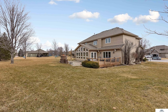 back of property featuring a yard and a deck