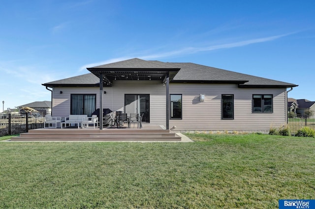 rear view of house featuring a yard and a deck