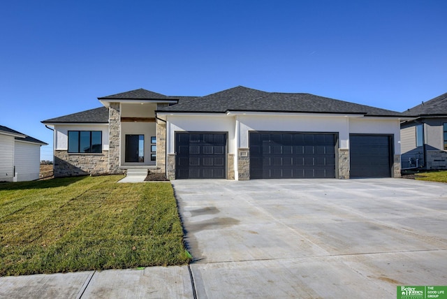 prairie-style house featuring a garage and a front lawn