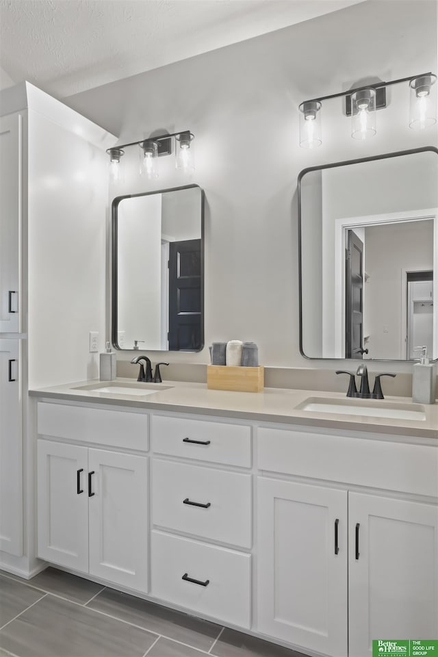 bathroom with vanity and a textured ceiling