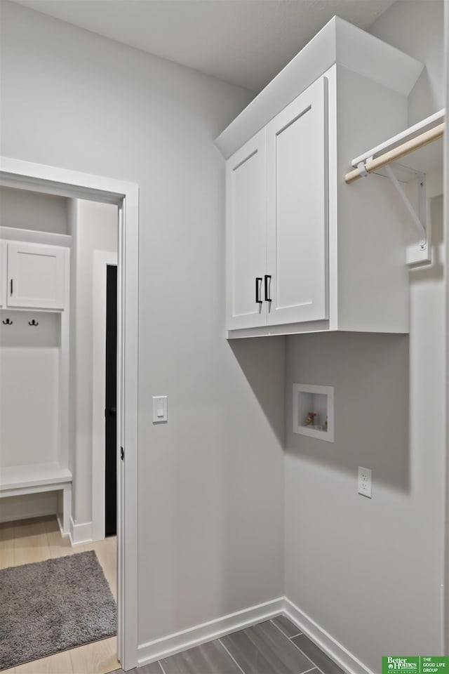 clothes washing area with cabinets and hookup for a washing machine