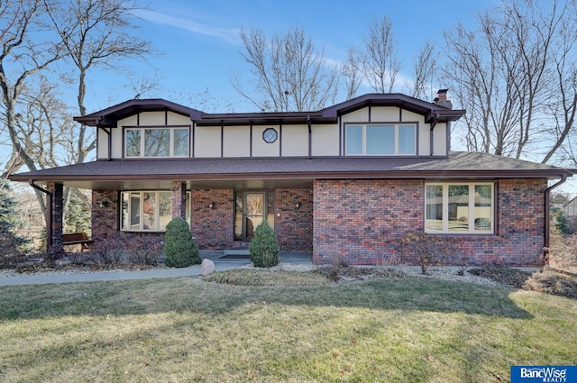 tudor-style house with a front yard