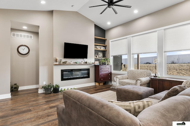 living room with built in shelves, vaulted ceiling, dark hardwood / wood-style floors, and ceiling fan