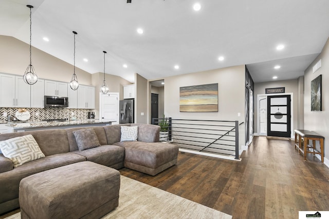 living room with dark hardwood / wood-style flooring and high vaulted ceiling