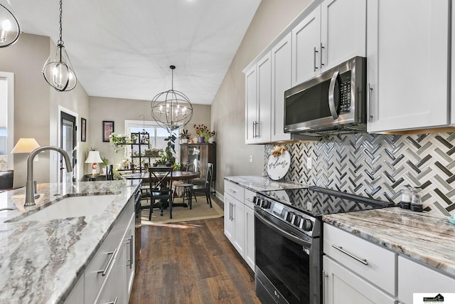 kitchen featuring appliances with stainless steel finishes, sink, and white cabinets