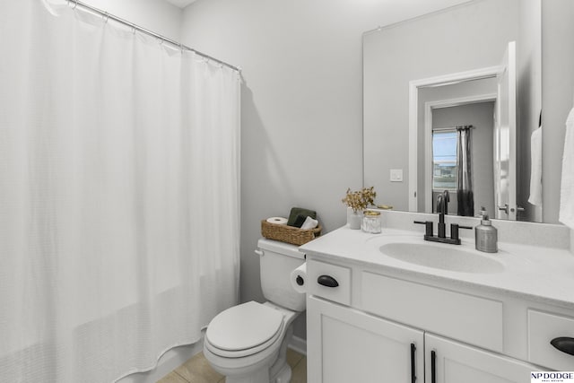 bathroom featuring walk in shower, vanity, toilet, and tile patterned flooring