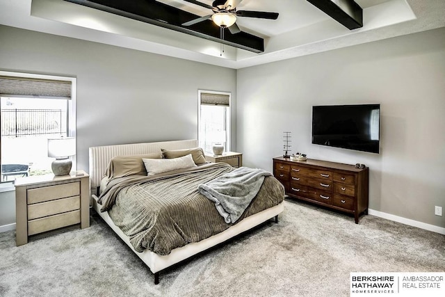 bedroom featuring beamed ceiling, ceiling fan, light colored carpet, and multiple windows