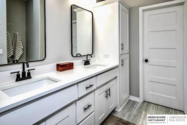 bathroom featuring vanity and wood-type flooring