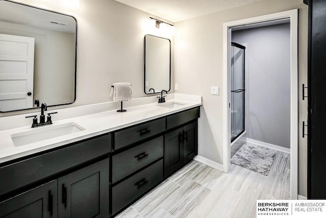 bathroom featuring vanity, an enclosed shower, and hardwood / wood-style floors