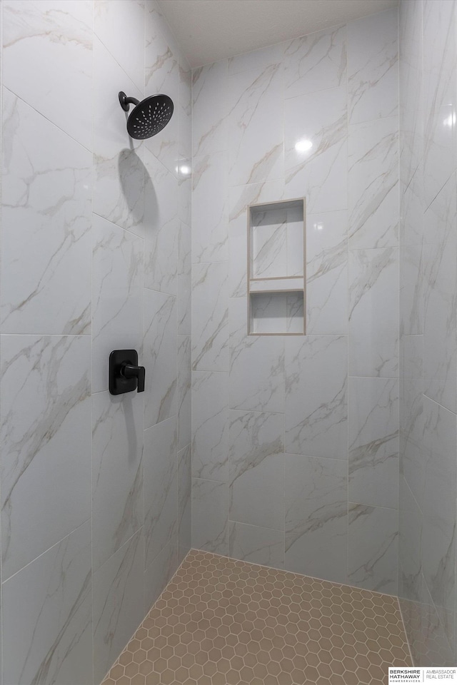 bathroom with a tile shower