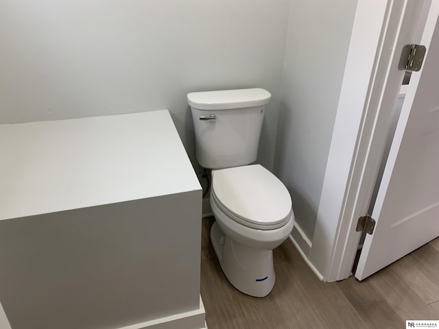 bathroom featuring hardwood / wood-style flooring and toilet