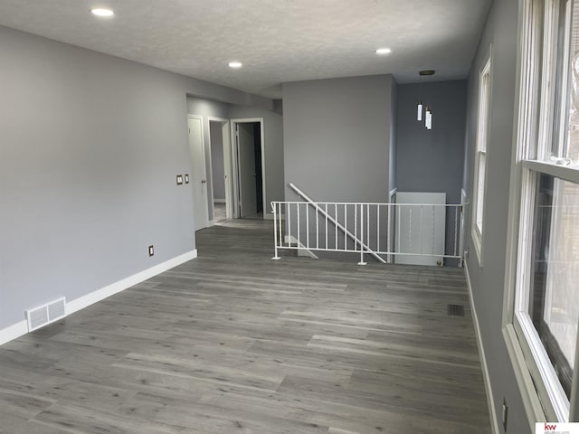 empty room featuring hardwood / wood-style flooring and a textured ceiling