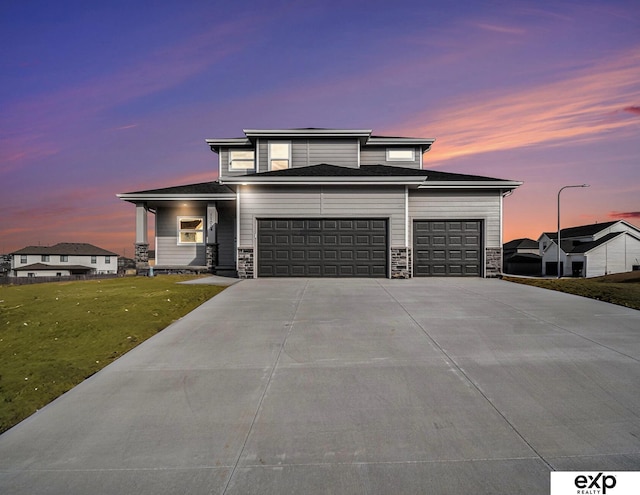 view of front of property with a yard and a garage