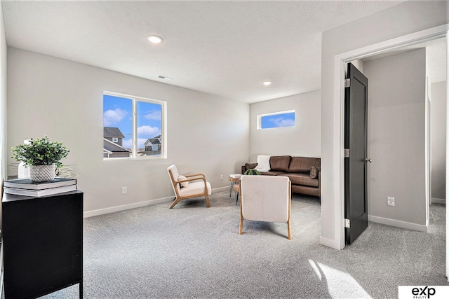 carpeted living room with a textured ceiling