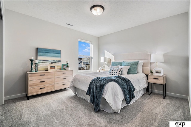 carpeted bedroom featuring a textured ceiling