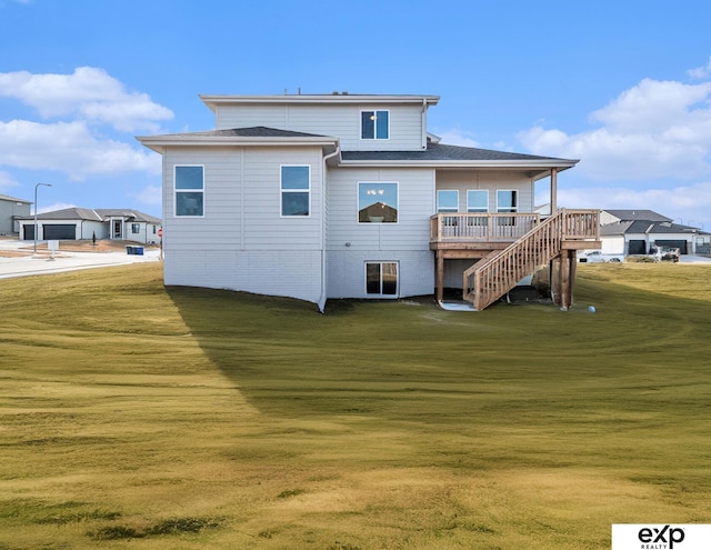 back of property featuring a wooden deck and a lawn