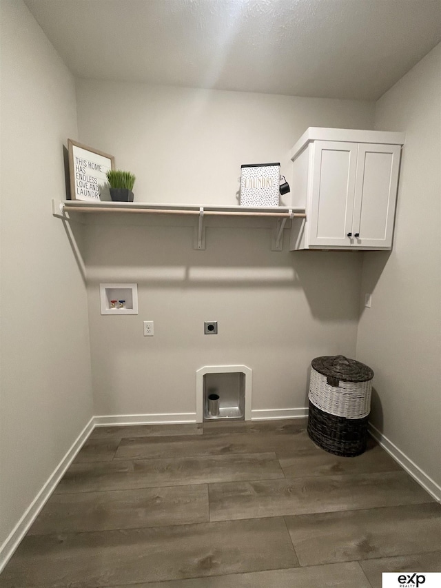 clothes washing area featuring hookup for a washing machine, dark hardwood / wood-style floors, hookup for an electric dryer, and cabinets