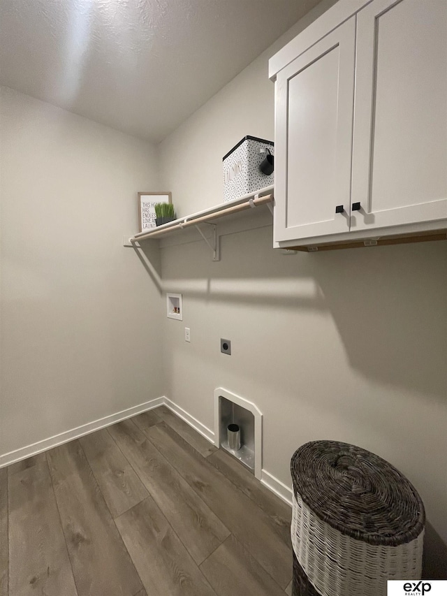 clothes washing area with hookup for a washing machine, electric dryer hookup, dark wood-type flooring, and cabinets