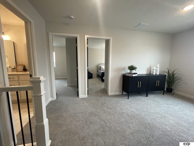 interior space with a textured ceiling and carpet