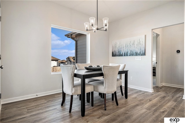 dining area with a chandelier and dark hardwood / wood-style flooring