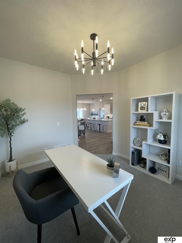 carpeted dining room featuring an inviting chandelier and a textured ceiling